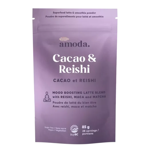 A warm cacao latte made with Amoda Cacao & Reishi blend, surrounded by adaptogenic ingredients