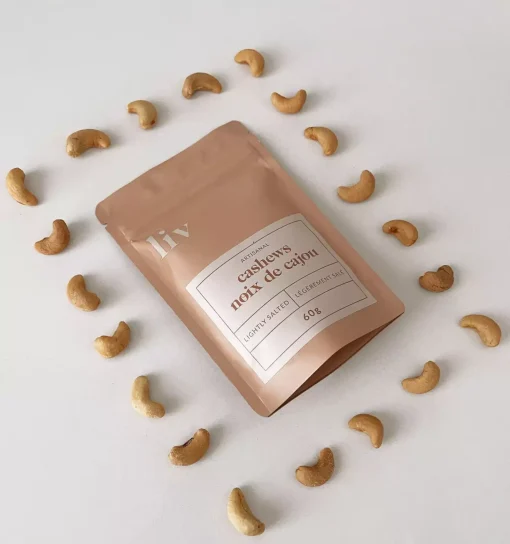 liv-gourmet-cashews-three-flavours Artisanal hand-roasted cashews by LIV in three gourmet flavours: Lightly Salted, Lime & Saffron, and Spicy (Mild), displayed in elegant packaging.