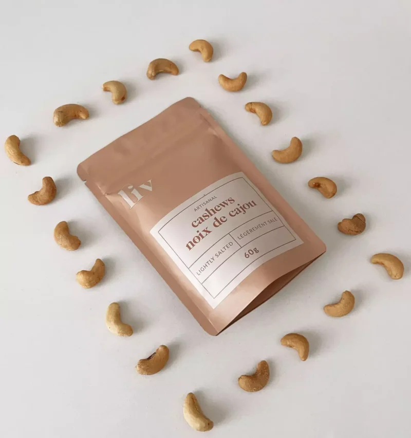 Artisanal hand-roasted cashews by LIV in three gourmet flavours: Lightly Salted, Lime & Saffron, and Spicy (Mild), displayed in elegant packaging.